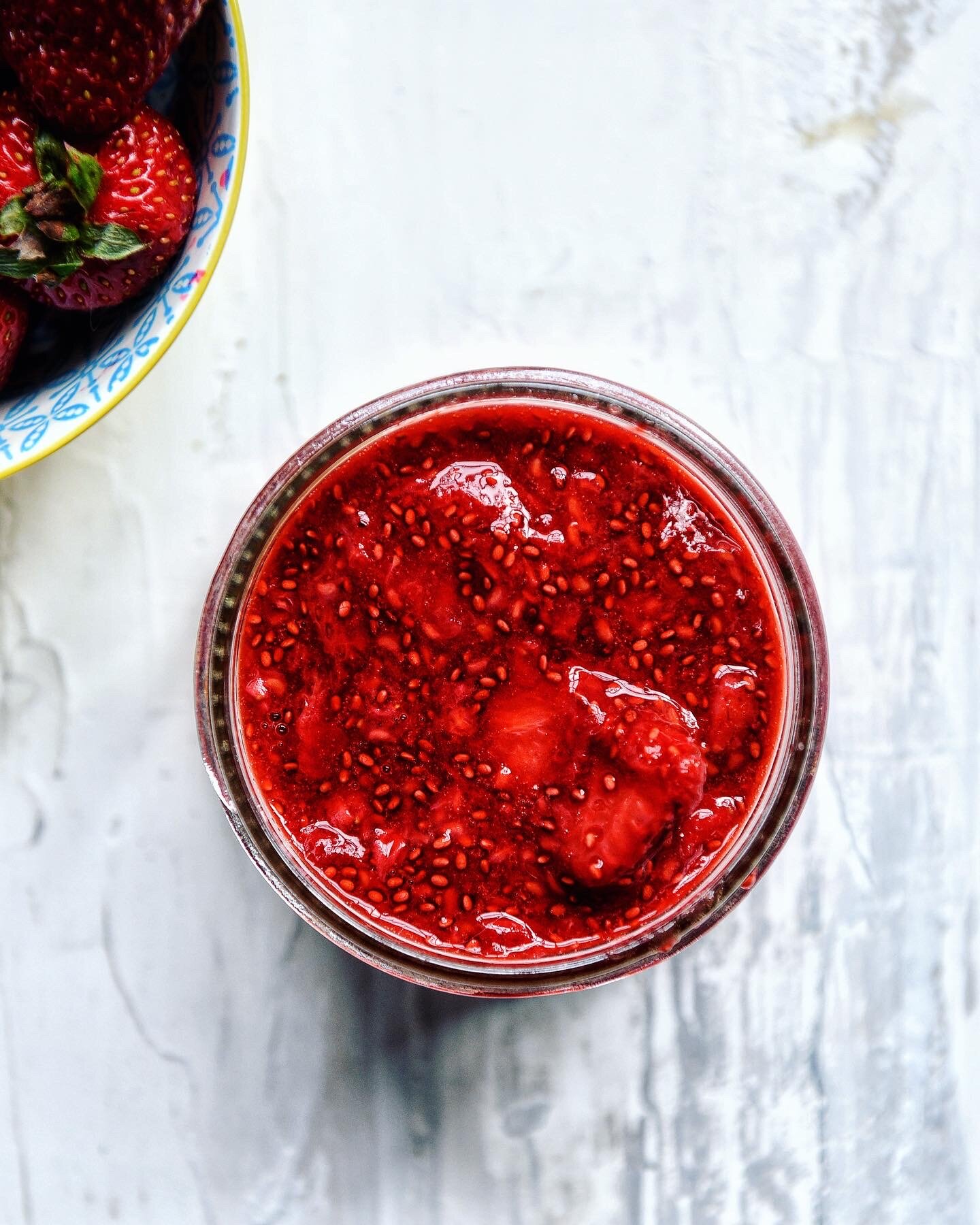 an arial view of strawberry raspberry chia jam in a jar.