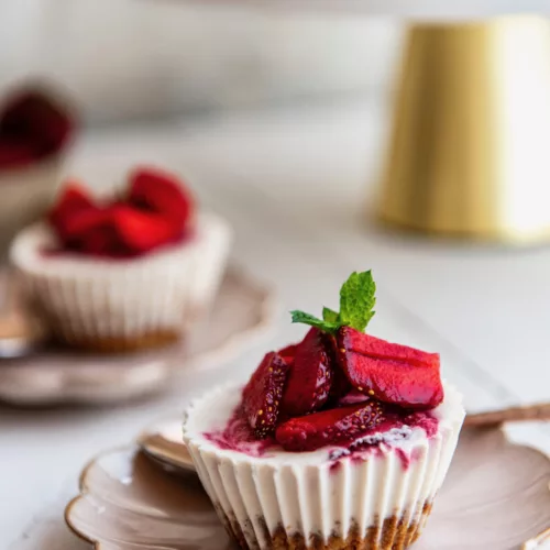 strawberry cheesecake cups on a decorative plate