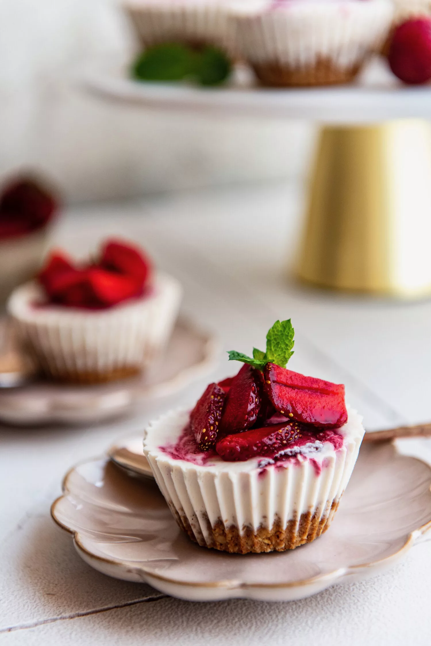 strawberry cheesecake cups on a decorative plate