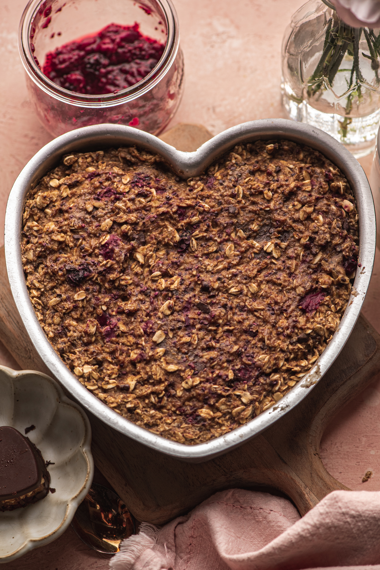 overhead view heart shaped bowl with baked homemade chocolate granola by teri-ann carty