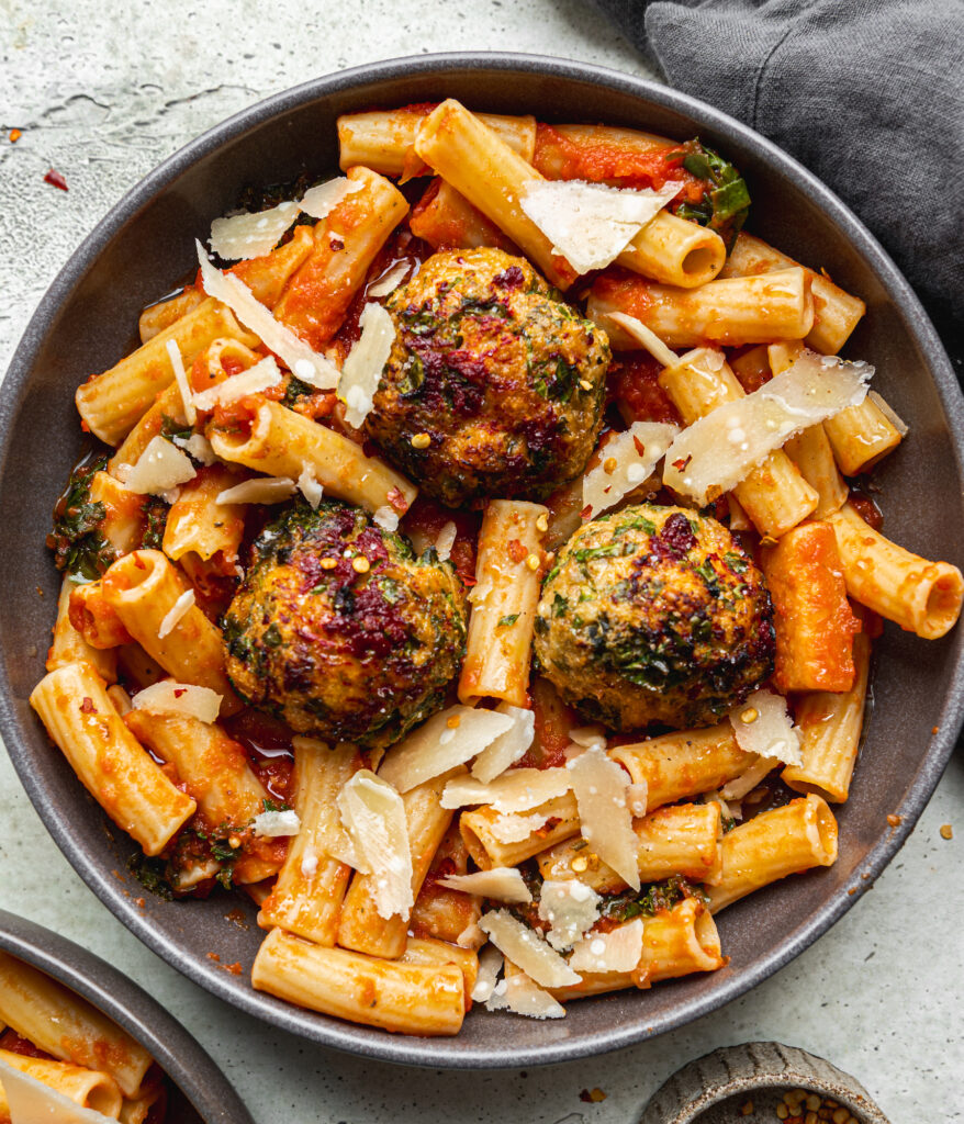 bowl of pasta with meatballs, includes shredded parmesan cheese by teri-ann carty