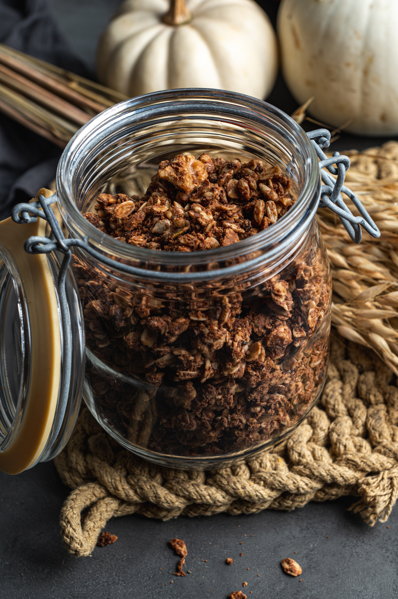 open glass jar with chocolate baked granola by Teri-Ann Carty