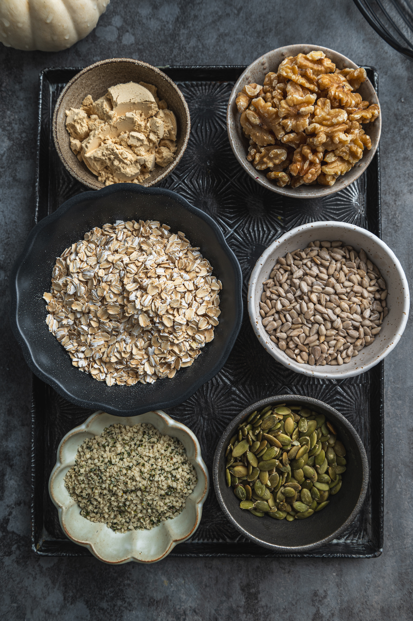 Overhead view of ingredients of granola in beautiful bowls by teri-ann carty