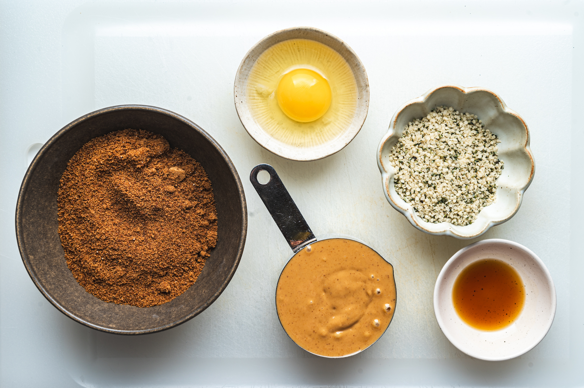overhead view of ingredients, egg, peanut butter and hemp seeds teri ann carty