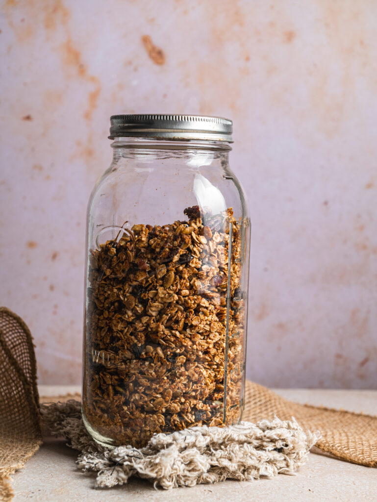 mason jar filled with gluten free granola by teri-ann carty