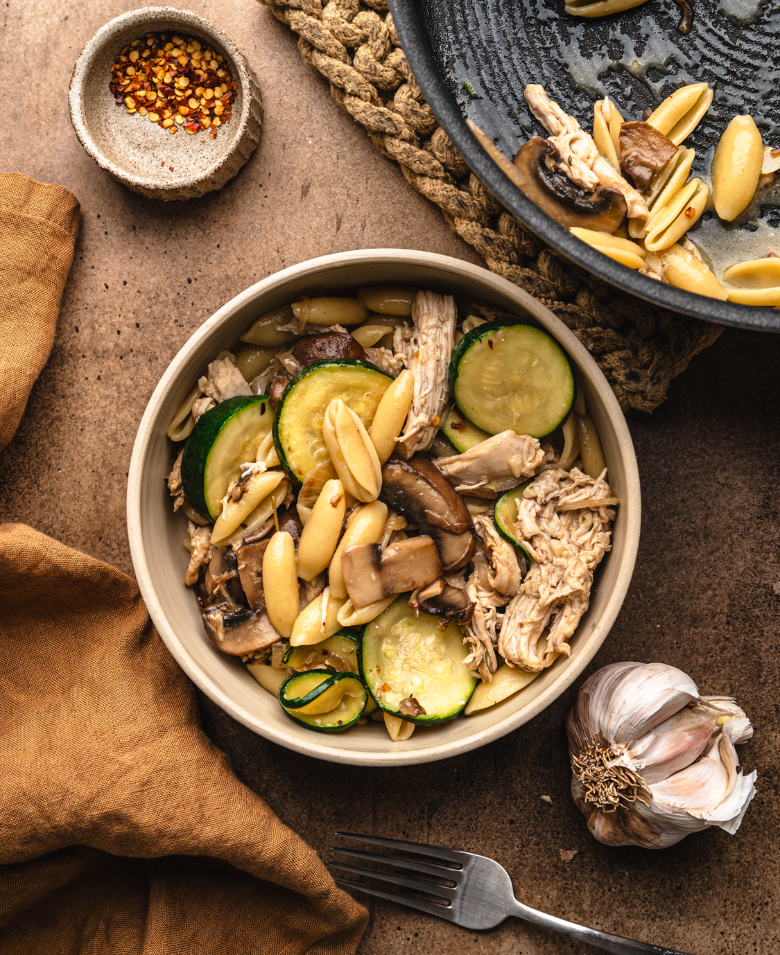 chicken pasta with zucchini and mushrooms served in a bowl