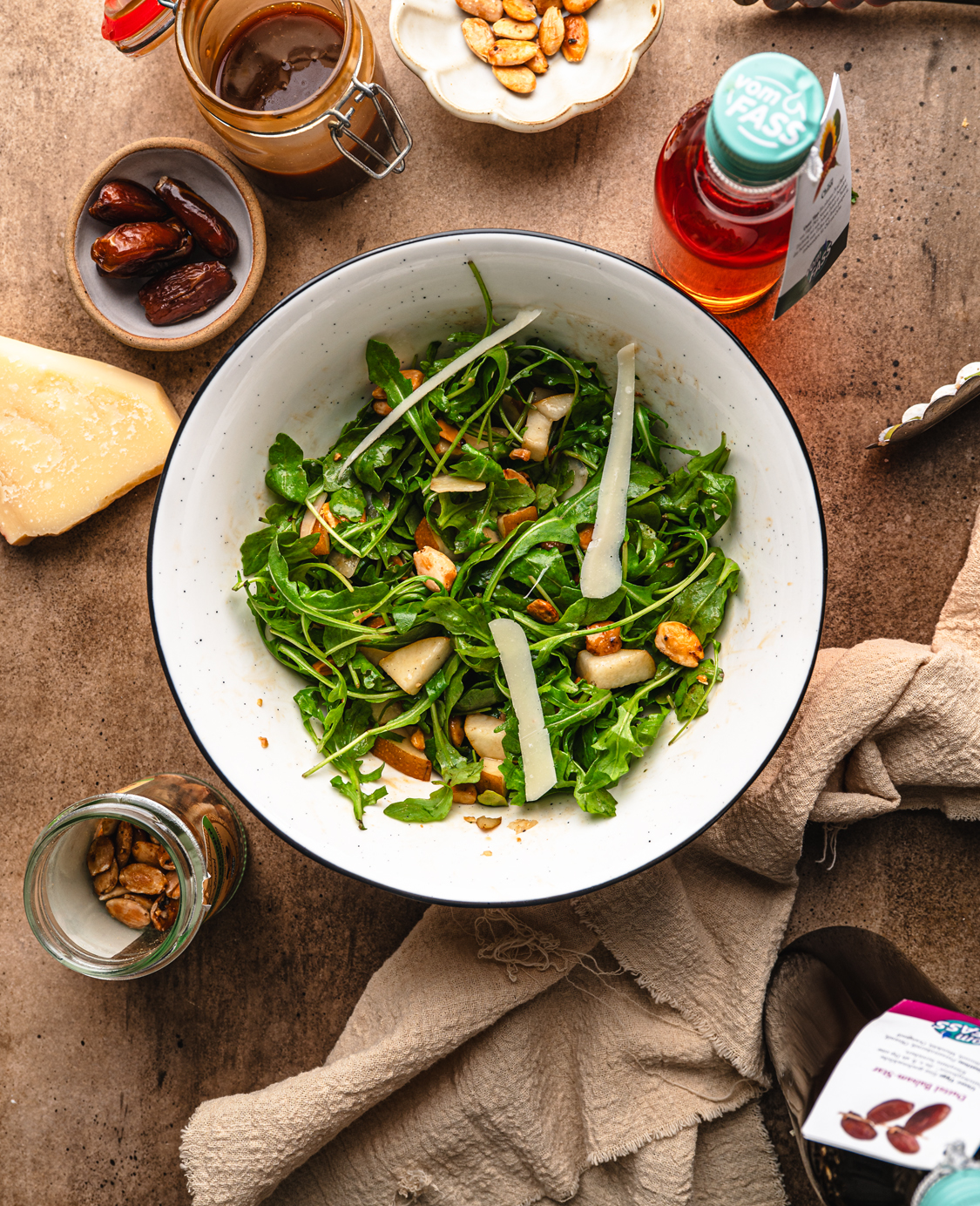 arugula and pear salad with toasted nuts, parmesan and date balsamic vinaigrette