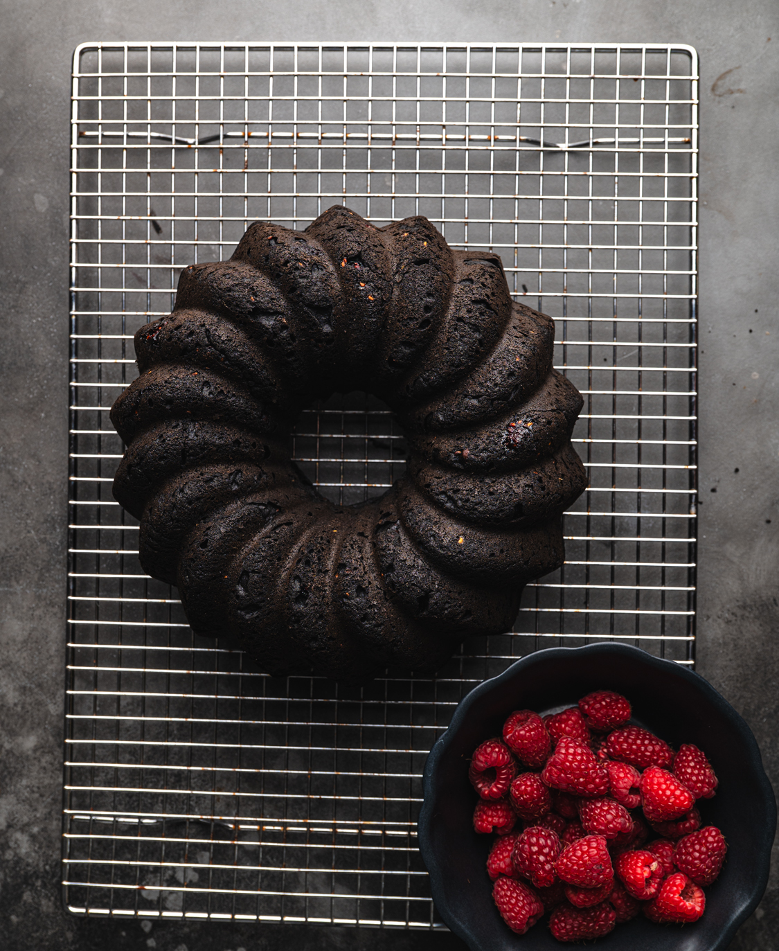 freshly baked gluten free chocolate ring cake base on a cooling rack