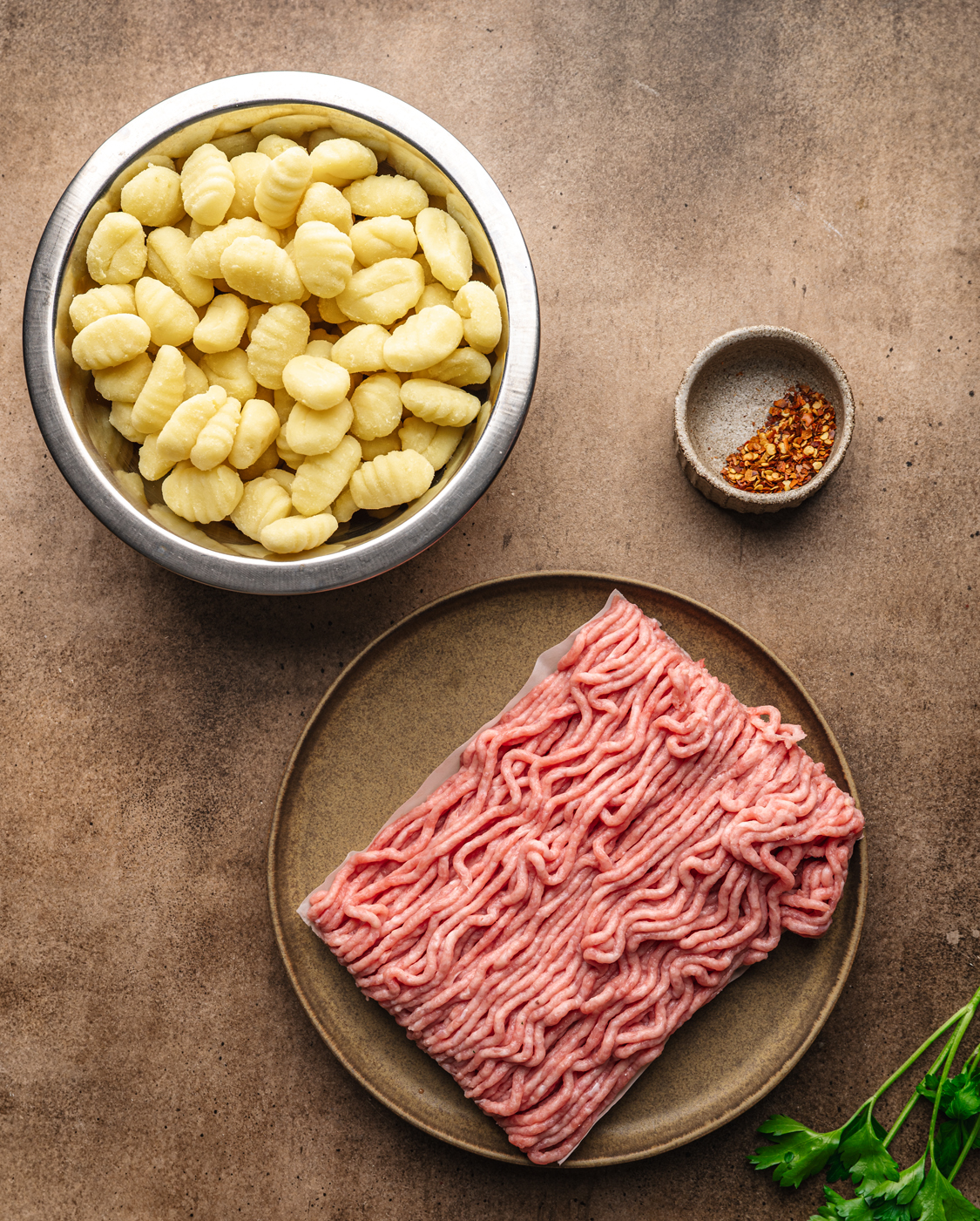Bowls with gnocchi, pepper flakes and turkey meat