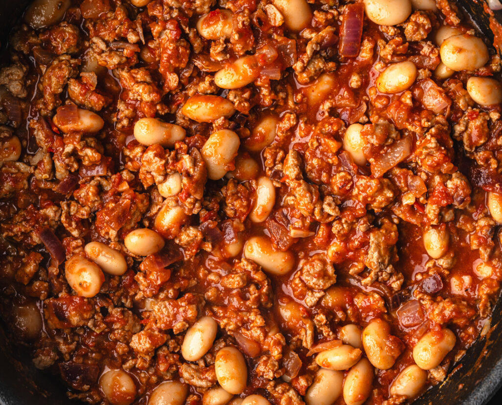 close up of ground chicken and white beans that will go into stuffed purple sweet potatoes