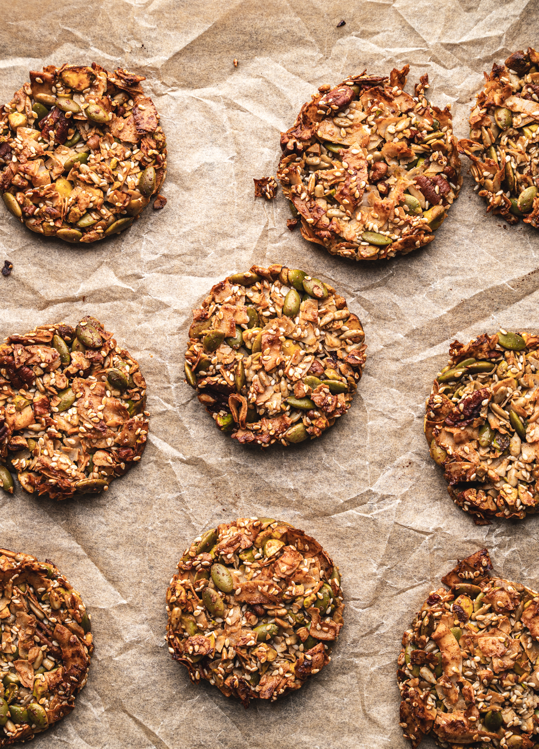 nine perfectly baked maple miso grain free granola cookies on parchment paper