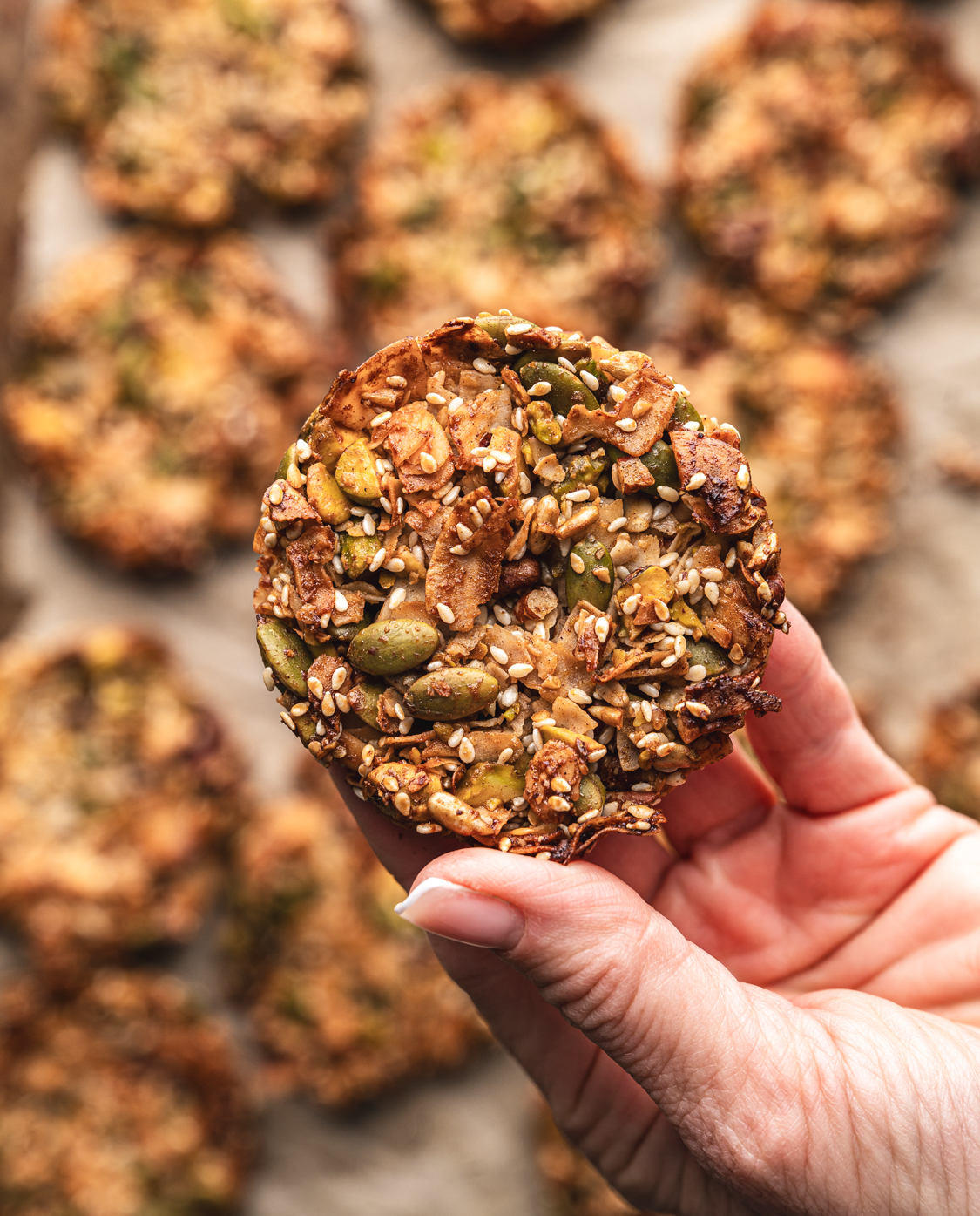 hand holding grain free granola cookies baked to perfection with a toasty crispy golden edge
