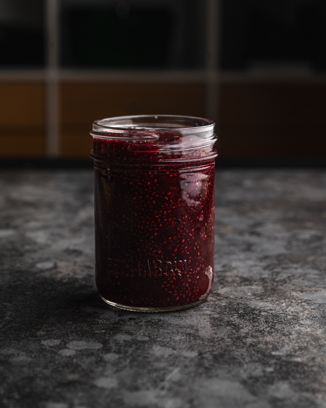 mason jar filled with delicious and deep red cherry jam made with chia seeds