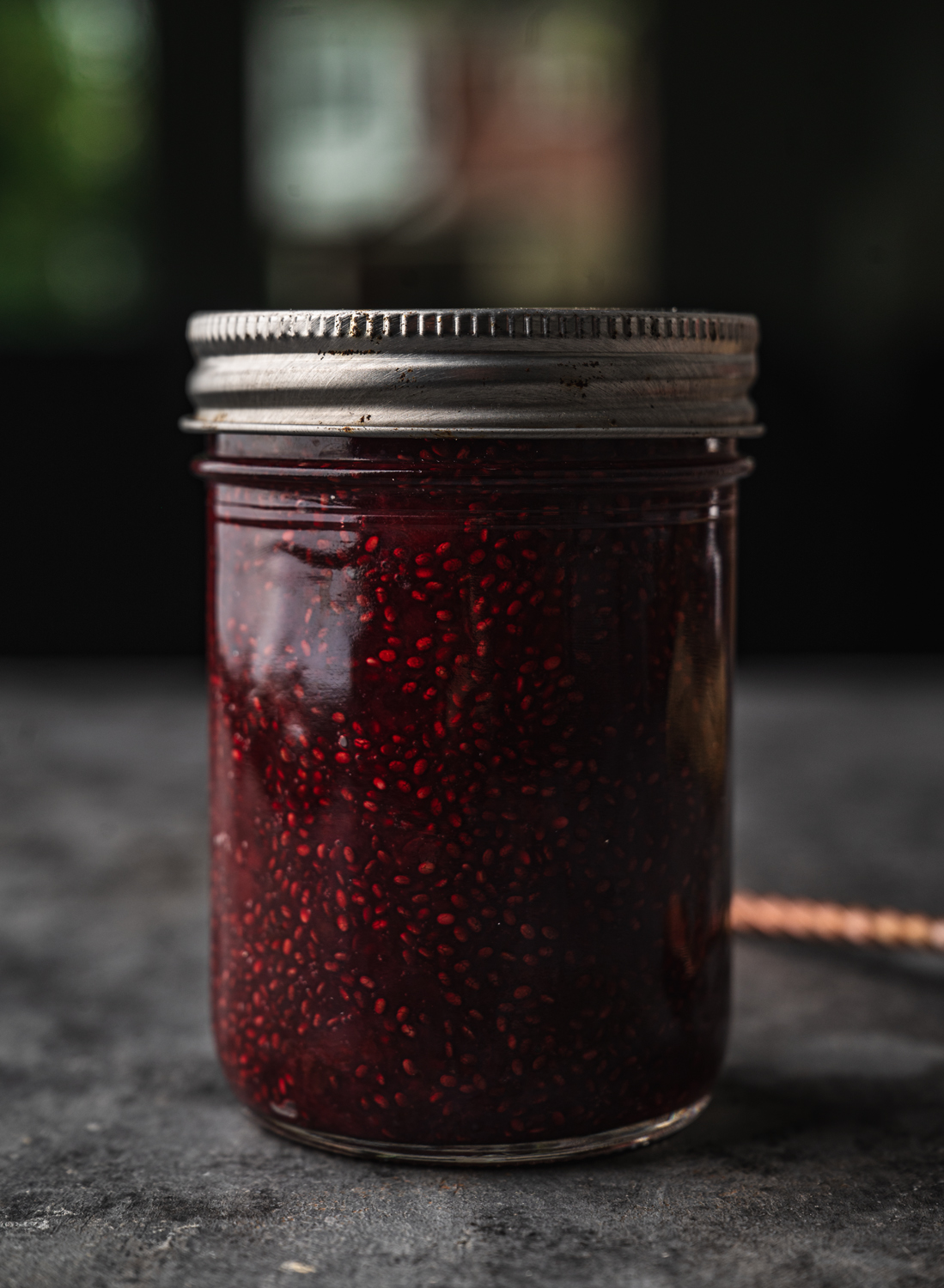 mason jar with a lid filled with homemade cherry jam