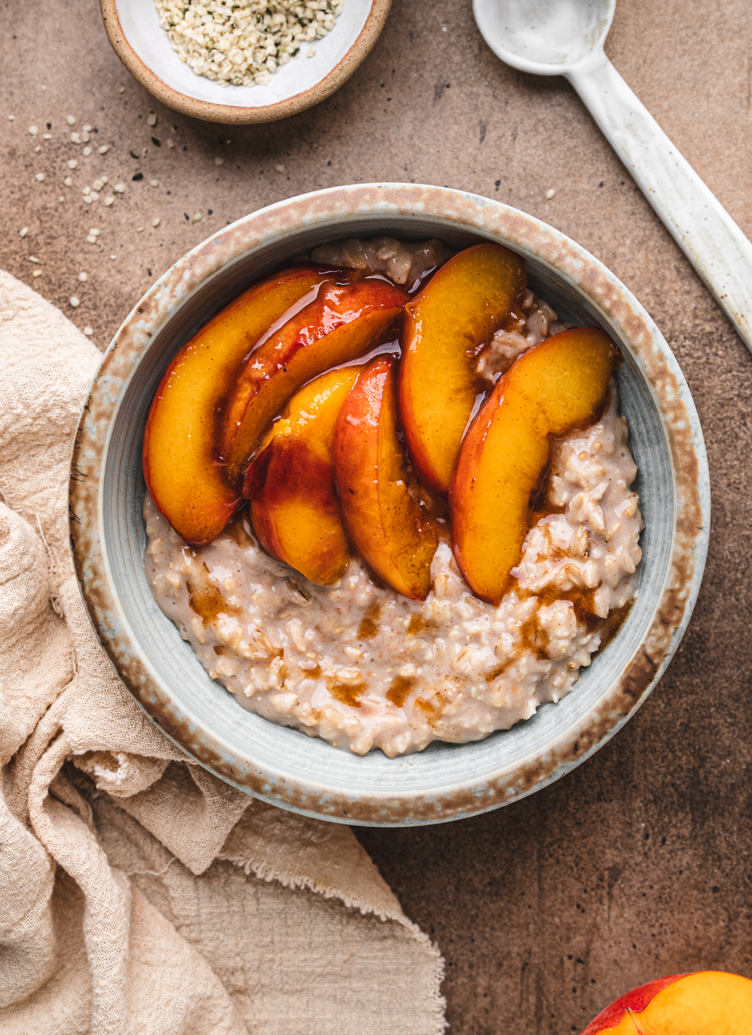 bowl with oats and juicy peach slices