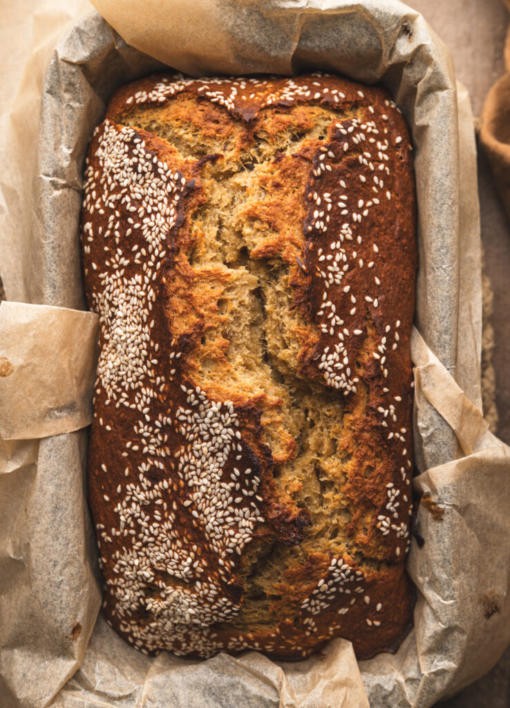 close up of freshly baked miso date banana bread in the tin