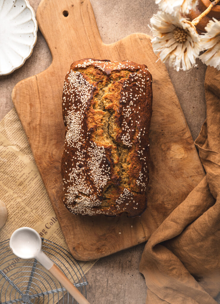 freshly baked miso date and banana bread on a large wooden cutting board