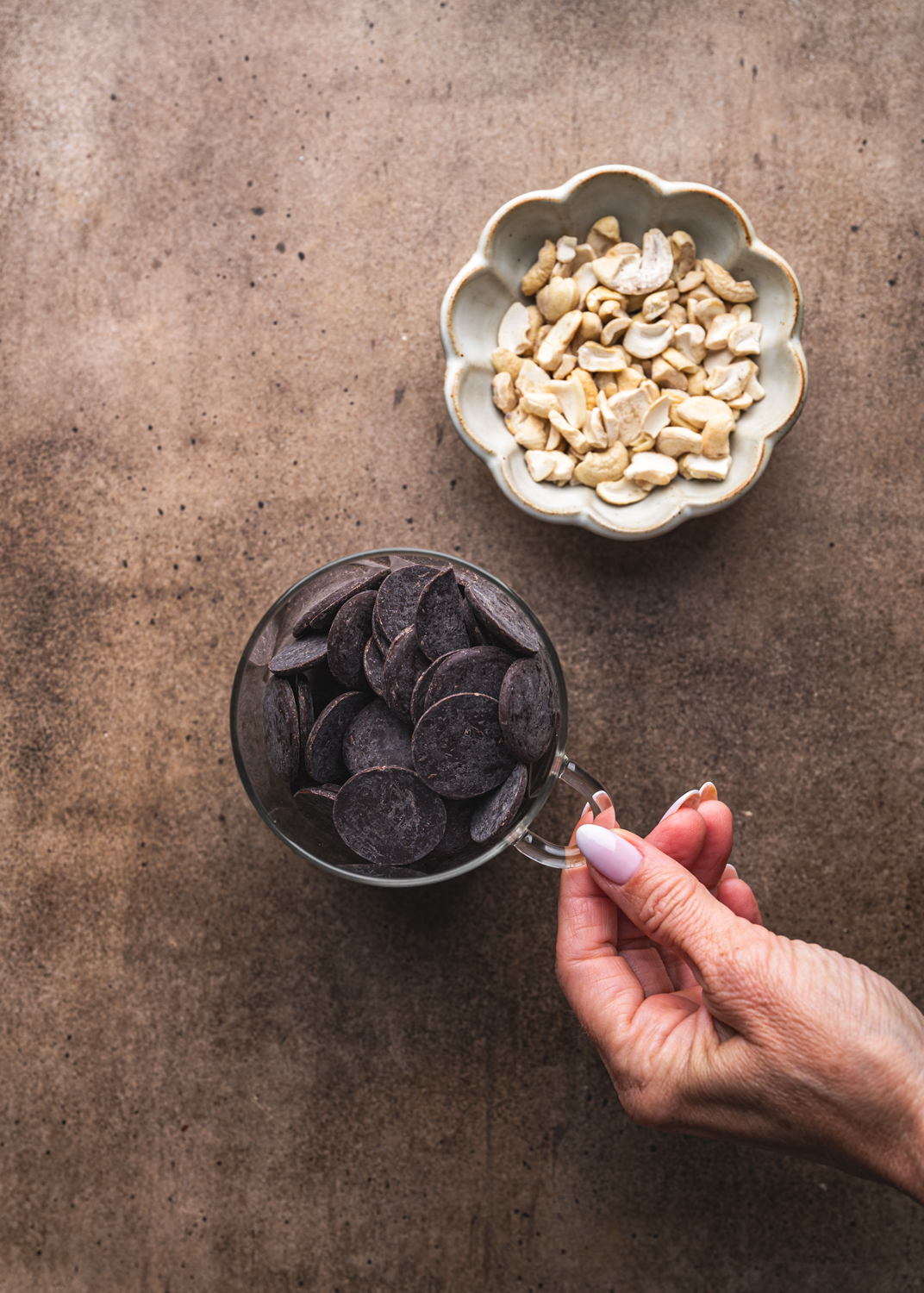 dark chocolate pieces and chopped cashews arranged for coating the mocha ice cream bars