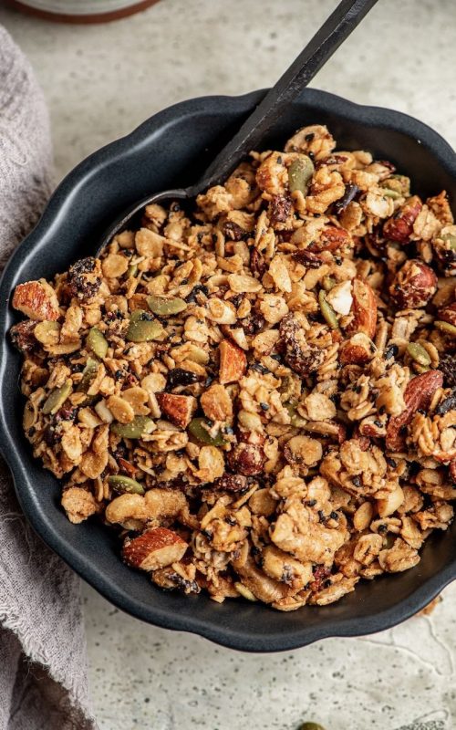 a black bowl filled with granola