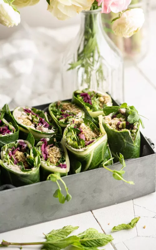 a metal box filled with lettuce wrapped falafel patties